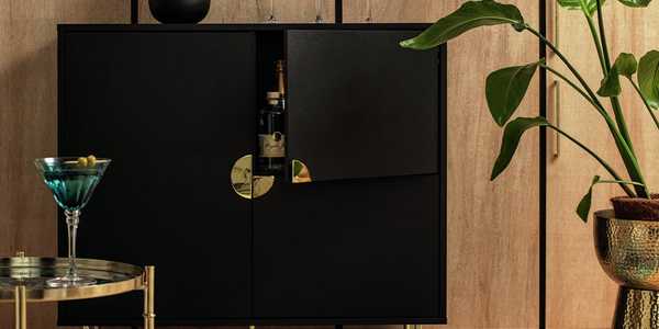 Black three door drinks cabinet with gold handles and accessories.